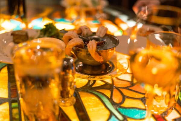 Close-up of handcrafted cocktails served on a warmly lit restaurant table.