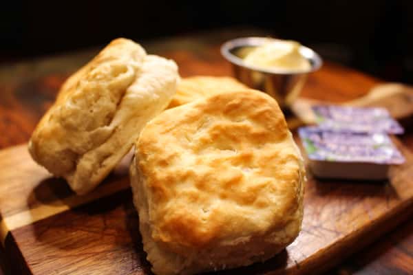 Freshly baked biscuits served warm with butter.