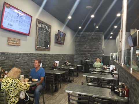 Two rows of tables with customers sitting at two of them