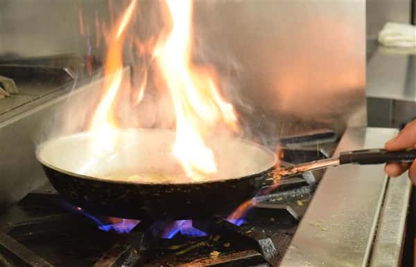 Pan that has fire coming out of it