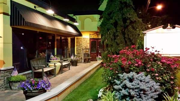 Entrance of Tuscany with tree's and flower bushes