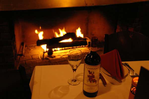 Wine and wine glass by the fire place