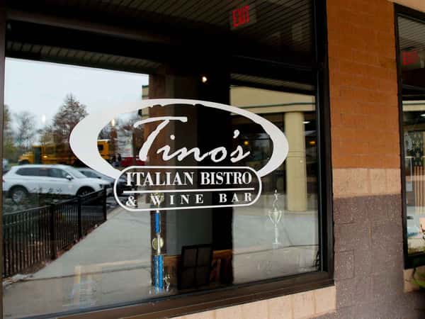 Glass wall with decal of Tino's restaurant name