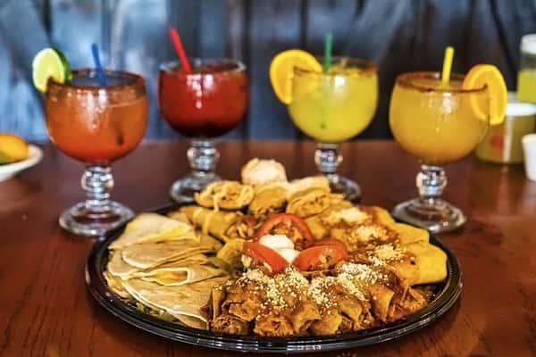 Mexican food and cocktails on a table