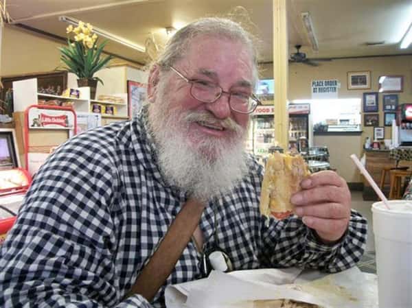Man smiling with a sandwich