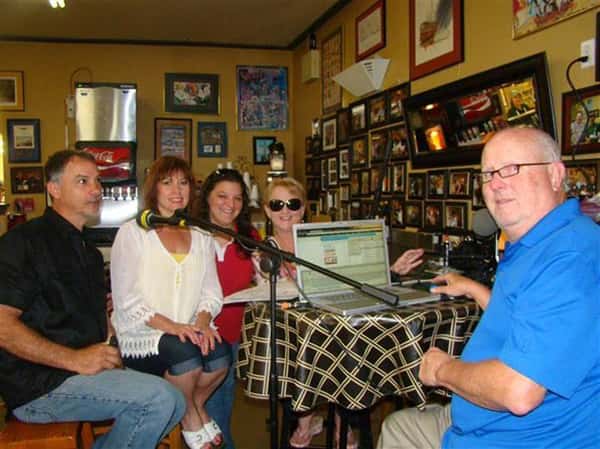 People smiling next to a microphone