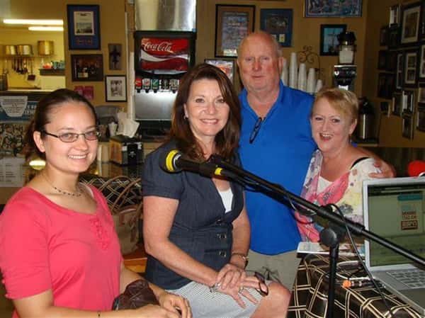 People smiling next to a microphone