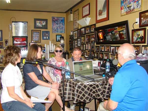 People sitting at a table with a microphone