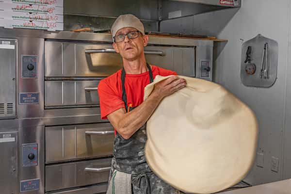 Pizza Chef pulling pizza dough