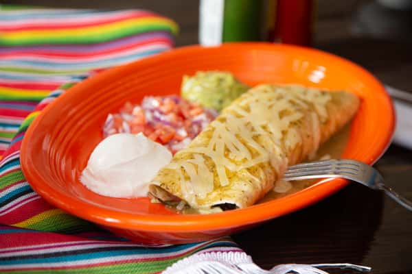 Gemini said A cheesy veggie burrito served on an orange plate with sides of sour cream, pico de gallo, and guacamole.