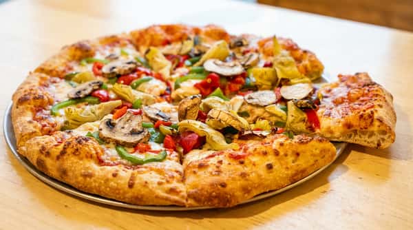 Pizza with artichoke hearts, mushrooms, bell peppers, and red sauce.