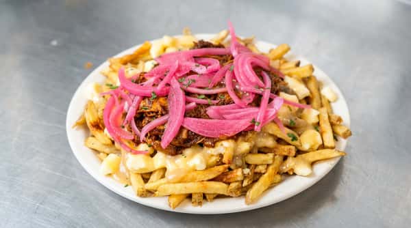 Poutine with fries, cheese curds, gravy, topped with pulled pork or meat, and pickled red onions.