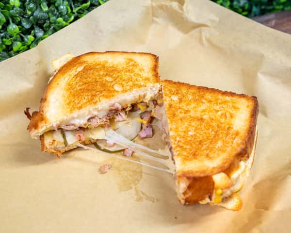 Grilled chicken sandwich halves on parchment paper