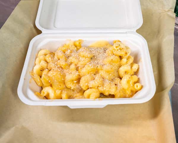 Mac and cheese served in a white takeout container