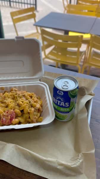 Take-out container with food and a canned drink at Mac-Shack