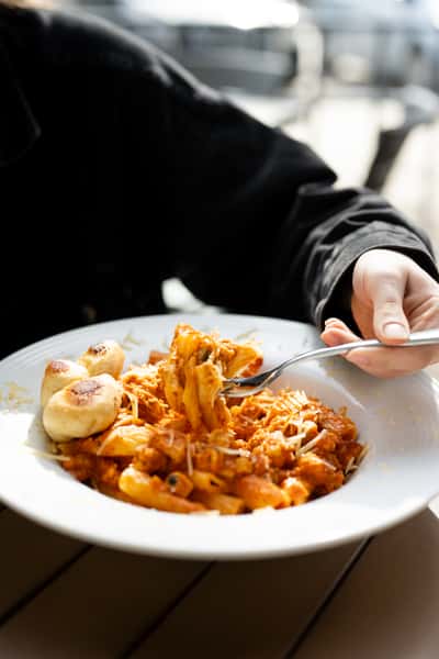 Guest enjoying a plated pasta dish