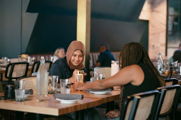 Guests enjoying creative twists on classic American food in McKinney and Frisco, TX