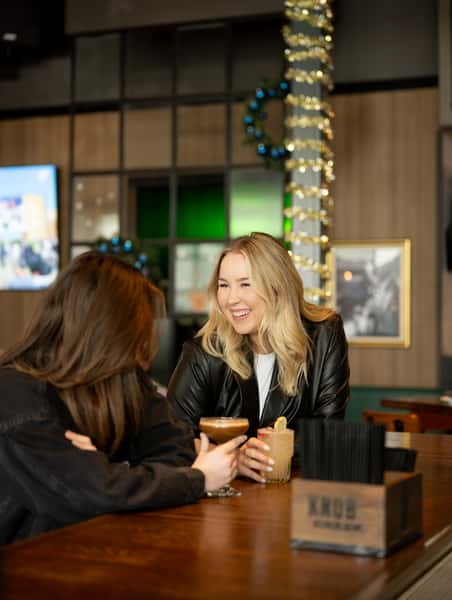 Guests sitting at the bar at The Common Table