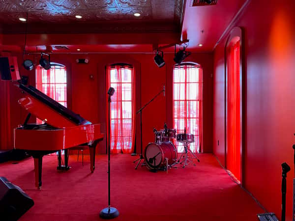 Room with different musical instrument and a red hue