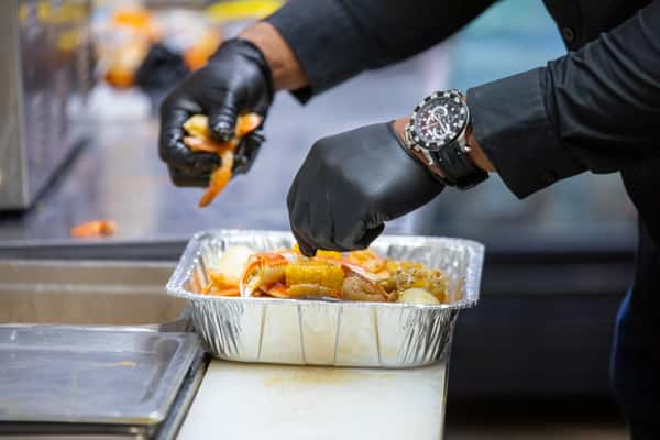 Placing seafood in a catering container