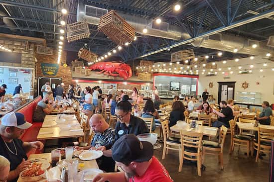 Busy dining area filled with guests at Boston Lobster Feast