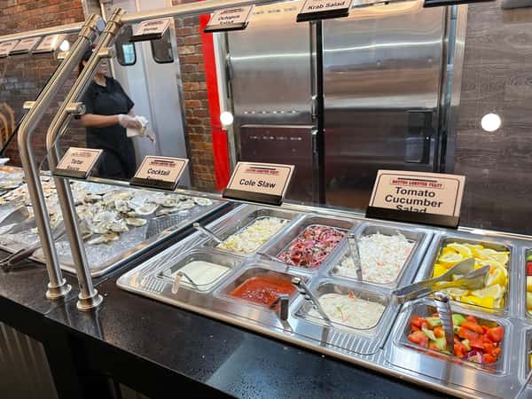 Seafood buffet station with chilled toppings, sauces and fresh selections at Boston Lobster Feast