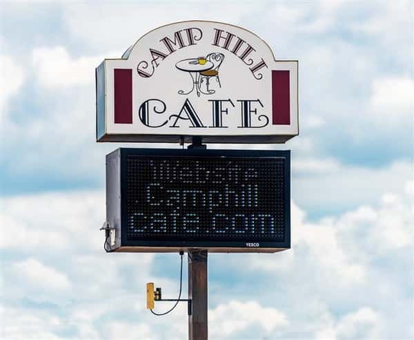 Camp Hill Cafe road sign with electronic readerboard underneath stating website camphillcafe.com