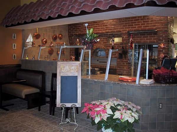 interior order counter with brick oven visiable behind the counter