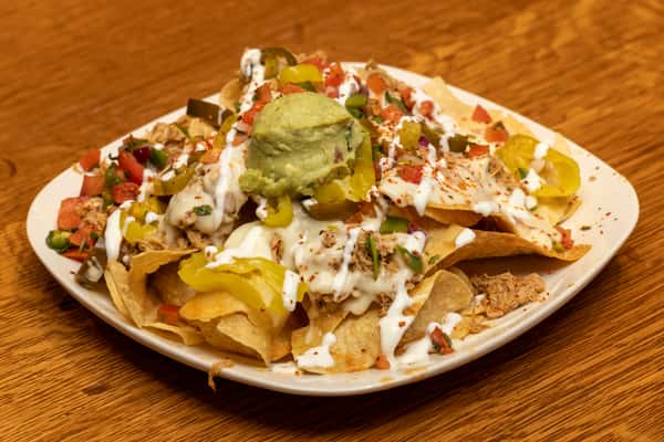 a plate of chicken nachos