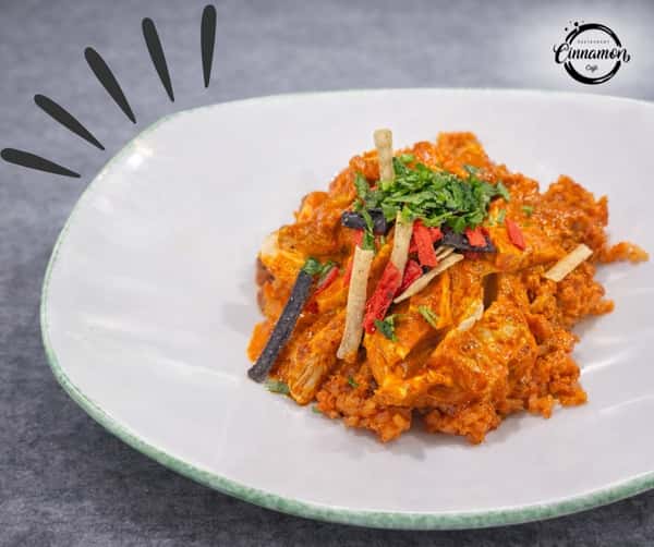 Salvadoran-style rice dish topped with grilled vegetables and fresh herbs.
