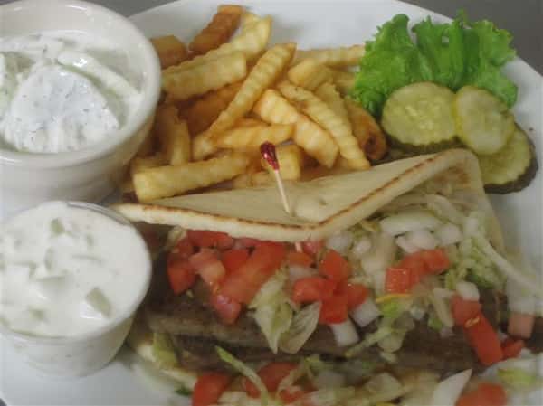 pita sandwich with lettuce, tomatoes, pickles, french fries and mayo