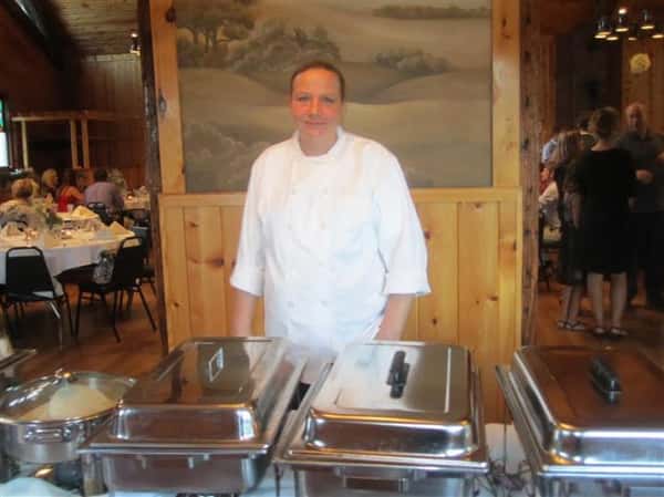 employee standing behind buffet table