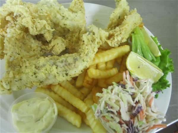 fried fish with french fries, coleslaw and sauce on the side