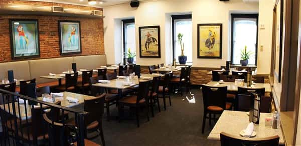 Dining area with paintings in the background