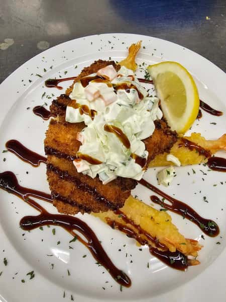 Panko-crusted shrimp topped with creamy cucumber slaw, drizzled with balsamic glaze and served with a lemon wedge.