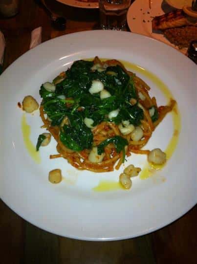 Pasta dish tossed with sauteed greens and scallops