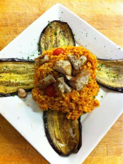 Chicken bites with orzo baked in tomato sauce and served with big slices of baked eggplant
