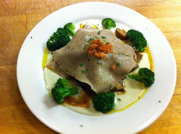 home made, whole wheat, open ravioli. This dish is stuffed with beef tenderloin and a wild mushroom ragu all served over a bed of blue cheese sauce and garnished with fresh broccoli florets