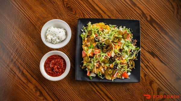 Crunch into Loaded Nachos at Dimitri's Opa Restaurant 🤤 Piled high with taco beef, lettuce, tomatoes, peppers, onions, olives, jalapeños, and melted cheddar cheese sauce over tortilla chips, then served with salsa and sour cream for the perfect finishing touch. 🧀
#LoadedNachos #DimitrisOpaRestaurant #NachoCravings #CheesyBites