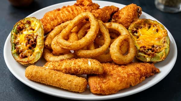 A plate of golden-brown fried foods including potato skins with melted cheese, onion rings, mozzarella sticks, and chicken tenders.