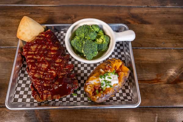 rib dinner with baked potato