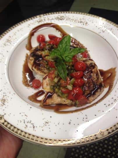 Grilled chicken aesthetically topped with vegetables