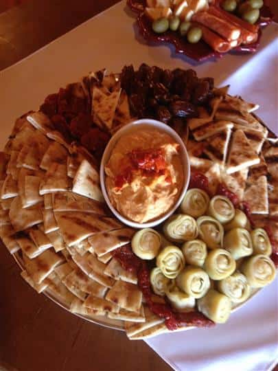 Pita chips, hummus, dates on platter