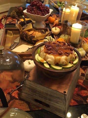 An autumn themed table setting with food on the table.