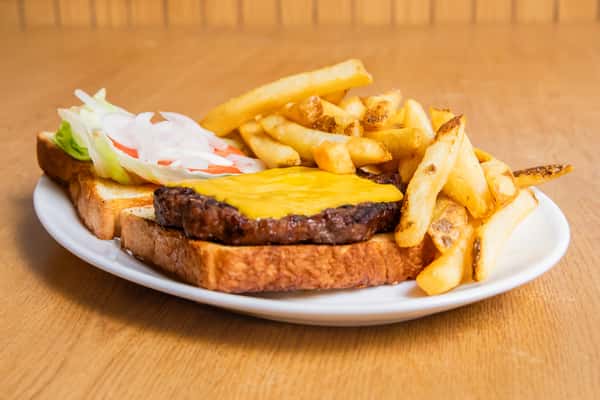 Cheeseburger on toast served open-faced with fries, lettuce, tomato and onion.