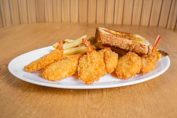 Breaded shrimp served with fries and toast, viewed from the side.