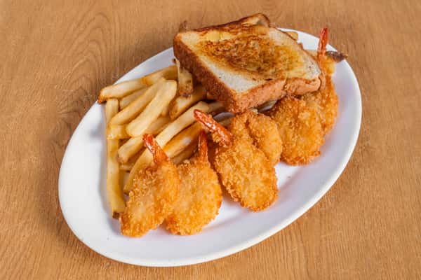 Golden breaded shrimp with french fries and toast on an oval plate.