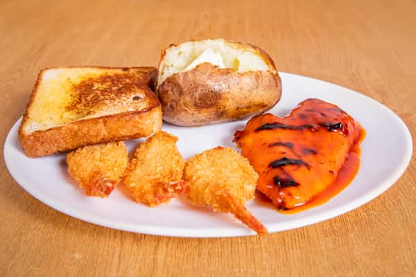 Grilled chicken and fried shrimp with toast and a baked potato.