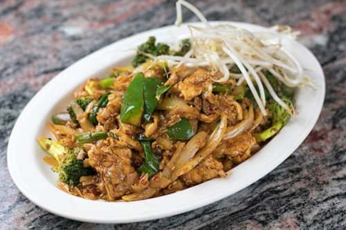 Rice noodles stir-fried with Broccoli, egg onions, & basil with your choice of meat.