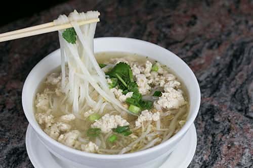 Rice noodles bean sprouts, green onions, and cilantro with your choice of protein in a clear broth.